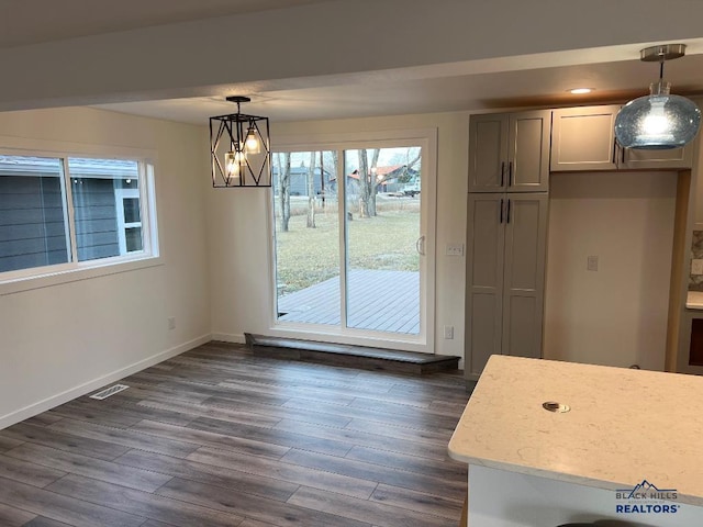 6920 Long View Rd, Rapid City, SD 57703 - unfurnished dining area with dark wood-style floors and baseboards