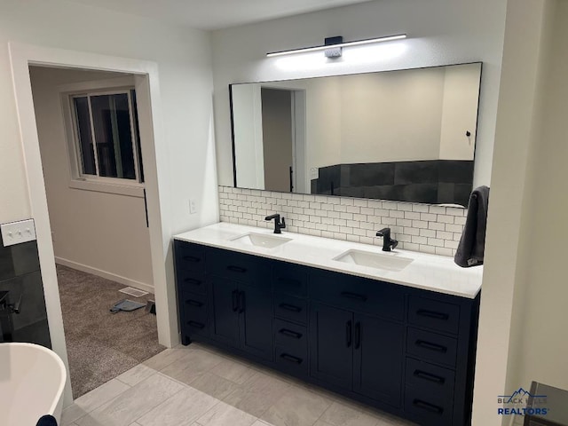 6920 Long View Rd, Rapid City, SD 57703 - full bathroom featuring double vanity, backsplash, and a freestanding tub