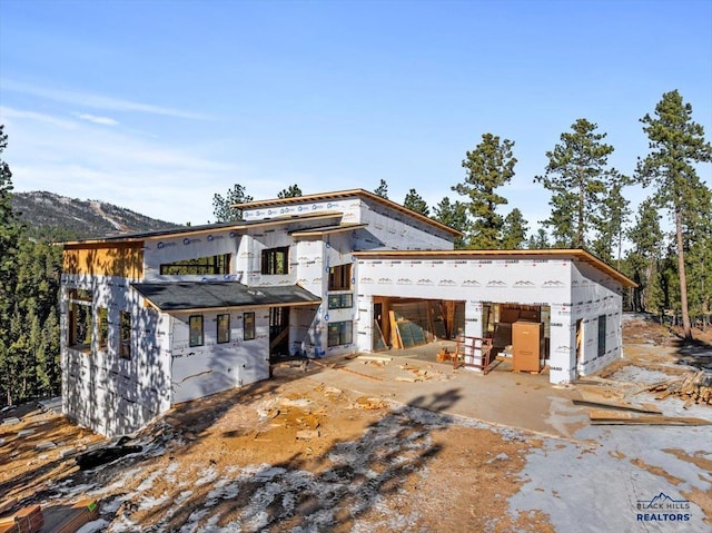 back of house with a mountain view