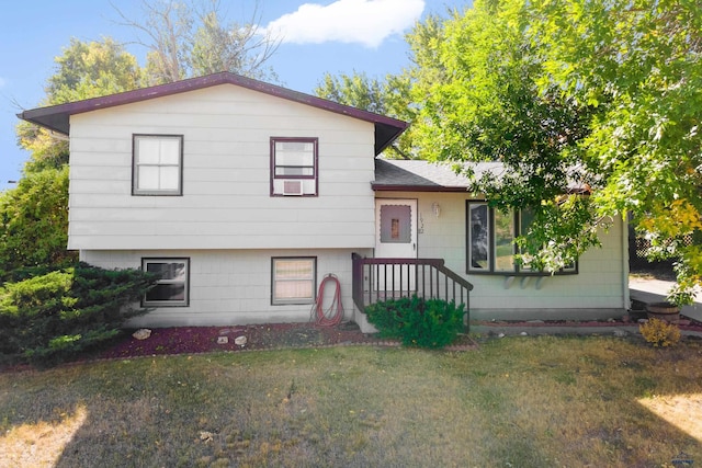 tri-level home with a front yard