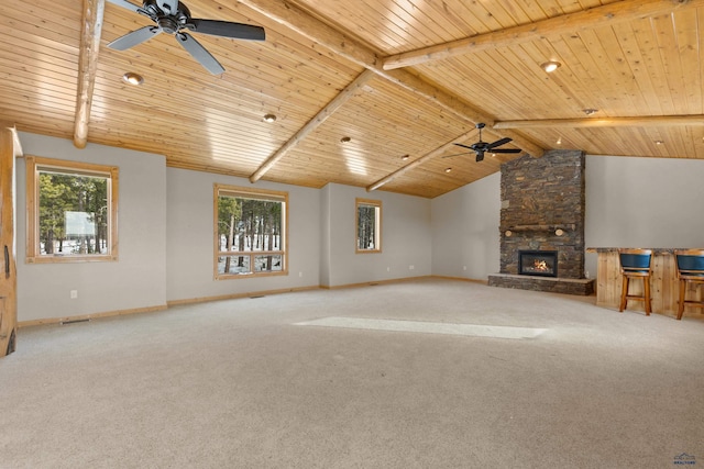 unfurnished living room with carpet flooring, plenty of natural light, and wooden ceiling