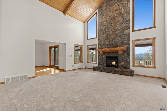 unfurnished living room with carpet flooring, high vaulted ceiling, and a wealth of natural light