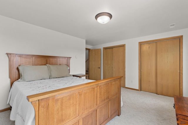 carpeted bedroom with two closets