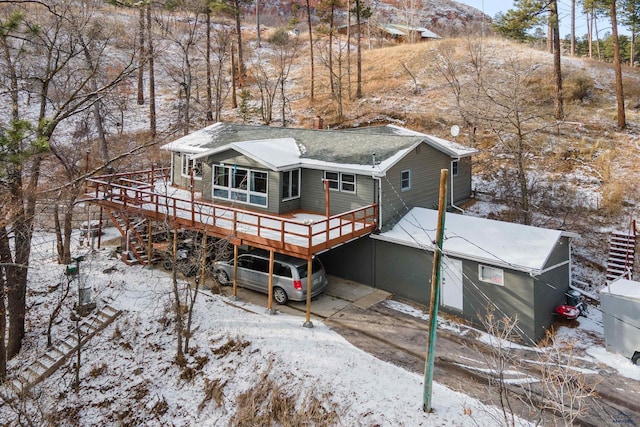 snow covered property featuring a deck