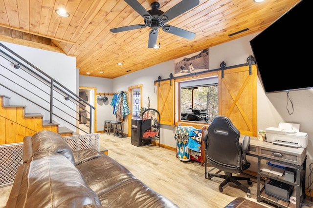 office area with a barn door, light hardwood / wood-style flooring, ceiling fan, and wooden ceiling