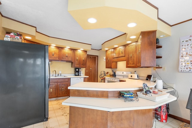 kitchen featuring kitchen peninsula, white appliances, crown molding, and sink