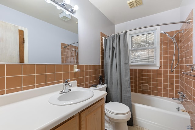 full bathroom with backsplash, shower / bath combination with curtain, toilet, vanity, and tile walls