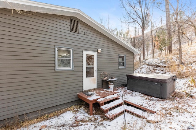 view of snow covered rear of property