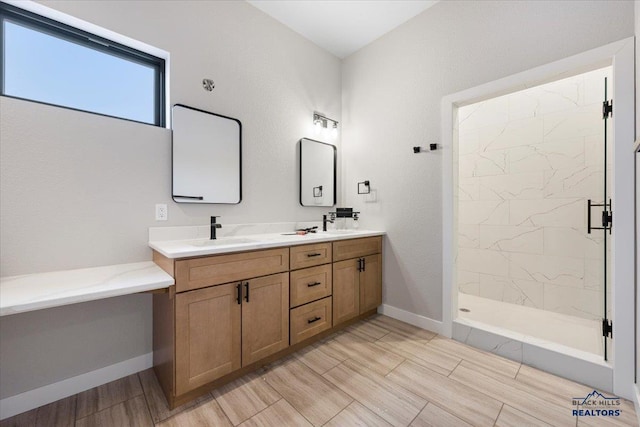 bathroom featuring a tile shower and vanity