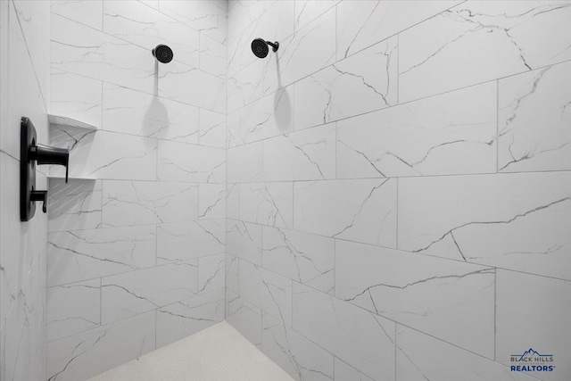 bathroom with a tile shower