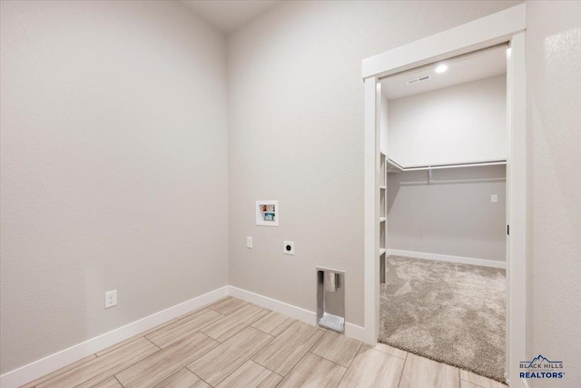 laundry area with hookup for an electric dryer, light colored carpet, and hookup for a washing machine