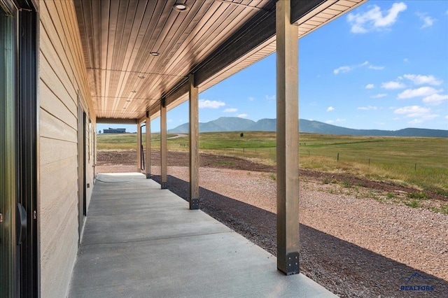 view of patio / terrace with a mountain view and a rural view