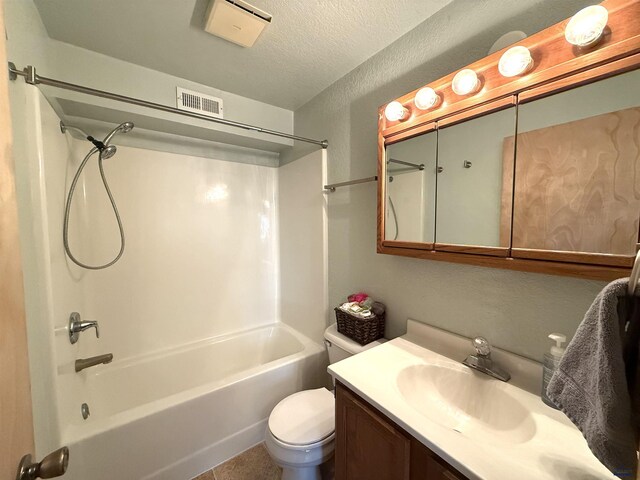 full bathroom with bathing tub / shower combination, vanity, a textured ceiling, and toilet