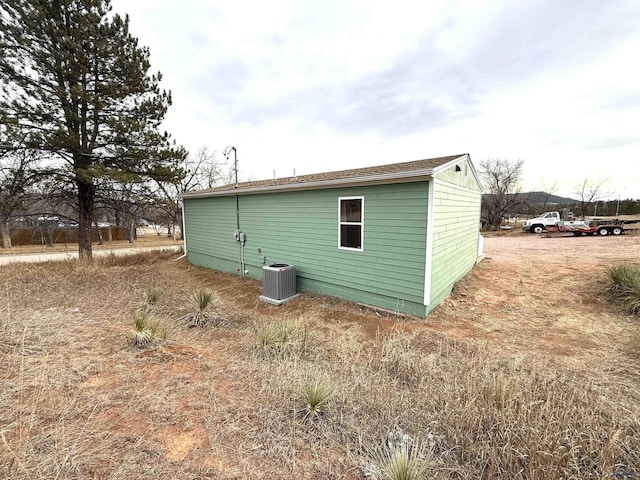 view of side of property featuring central air condition unit