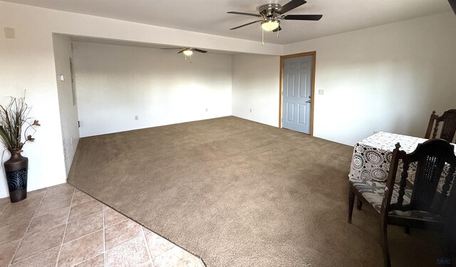 interior space with ceiling fan and light colored carpet