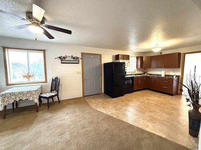 kitchen with a textured ceiling, light colored carpet, ceiling fan, and black appliances