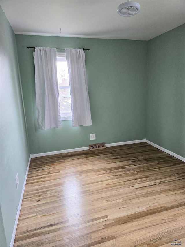 unfurnished room with light hardwood / wood-style flooring