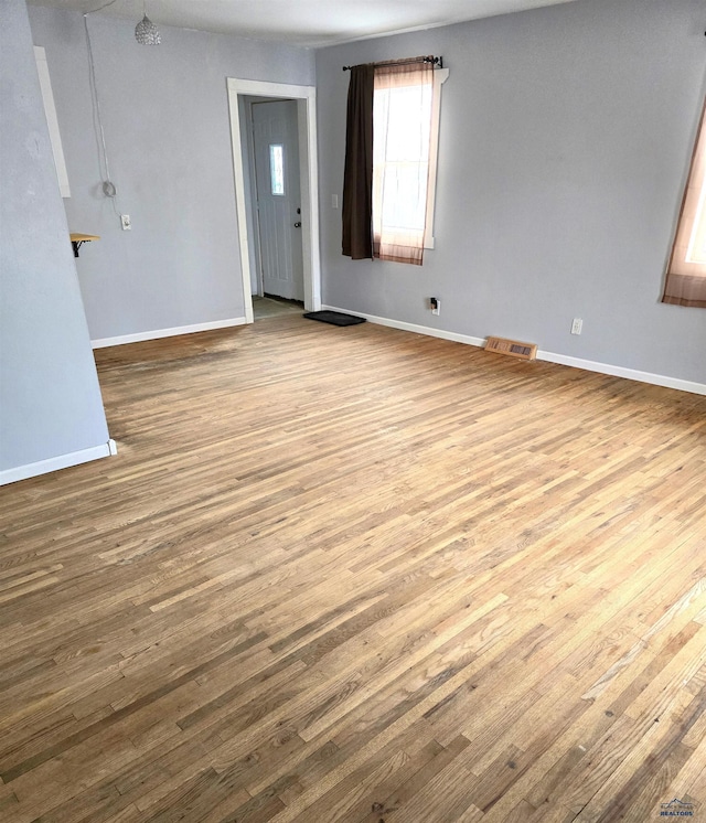 empty room with light hardwood / wood-style floors