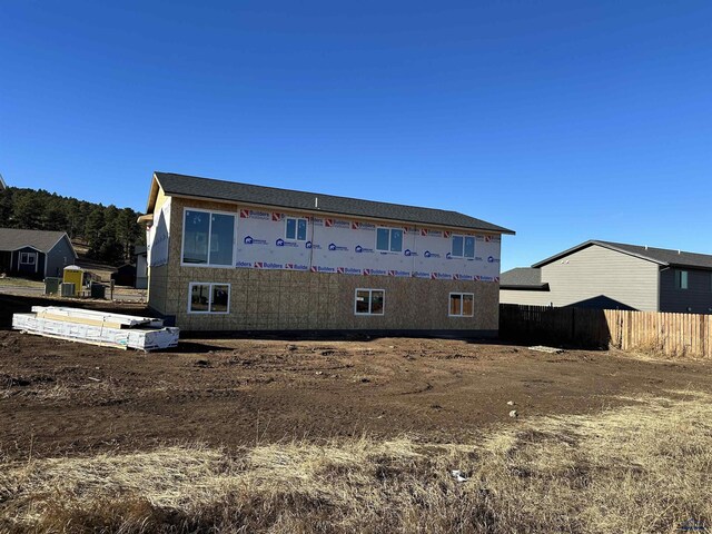 rear view of house with fence