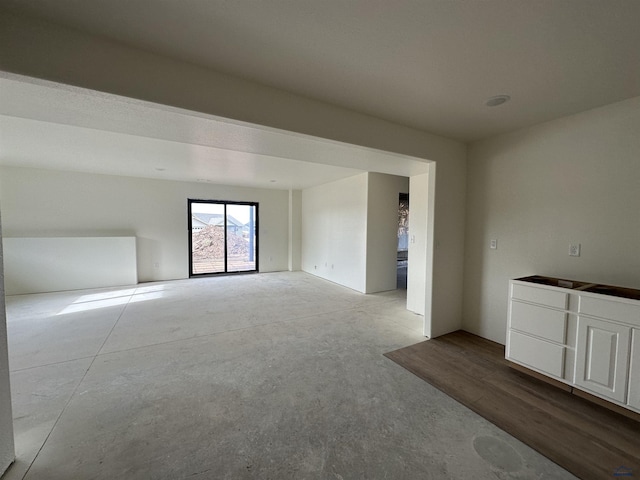 empty room with unfinished concrete flooring