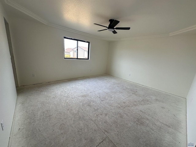 empty room with a ceiling fan and crown molding