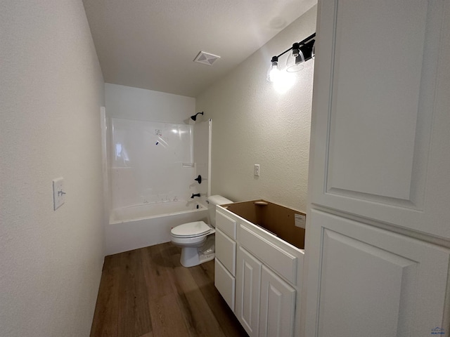 full bath featuring toilet,  shower combination, wood finished floors, visible vents, and a textured wall