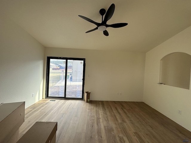 spare room with visible vents, ceiling fan, and wood finished floors