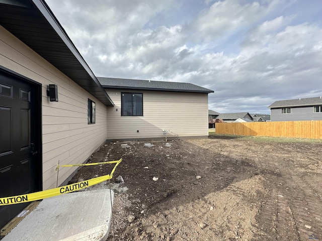 view of property exterior with fence