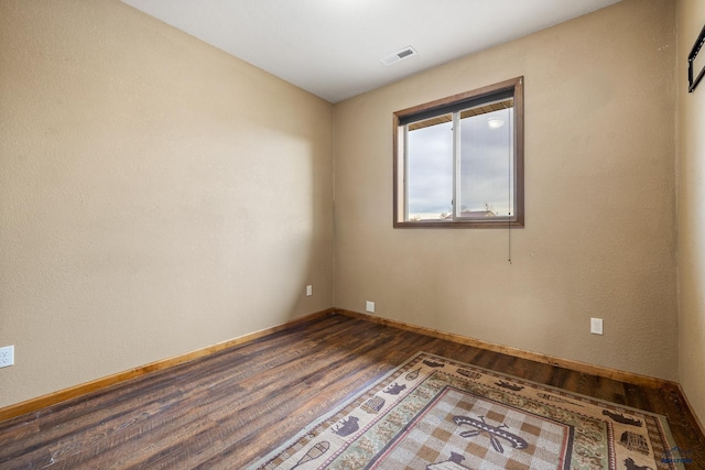 empty room featuring dark hardwood / wood-style floors