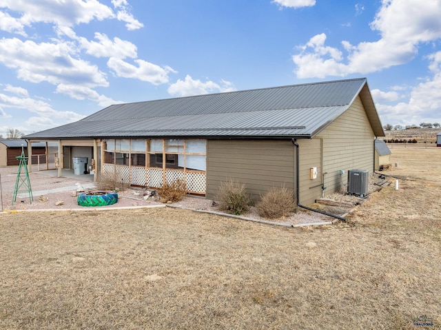 back of house with central AC