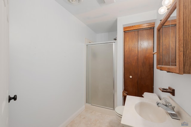 bathroom with toilet, sink, and walk in shower