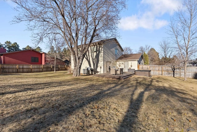 back of property with a lawn, a wooden deck, and central air condition unit