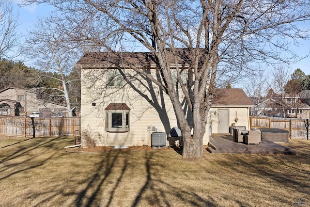 back of property with a lawn, cooling unit, a hot tub, and a storage shed