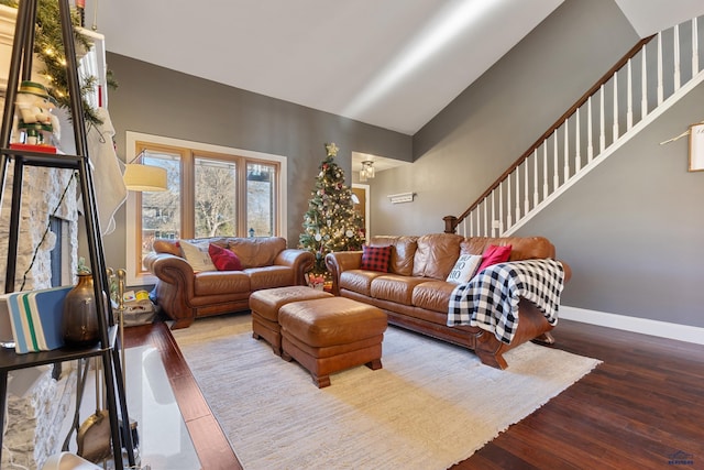 living room with hardwood / wood-style flooring and high vaulted ceiling