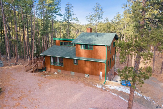 view of side of property with a wooden deck