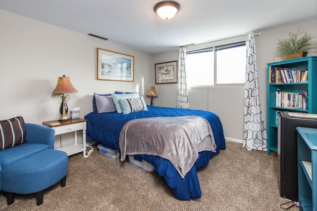 bedroom featuring a textured ceiling and carpet floors