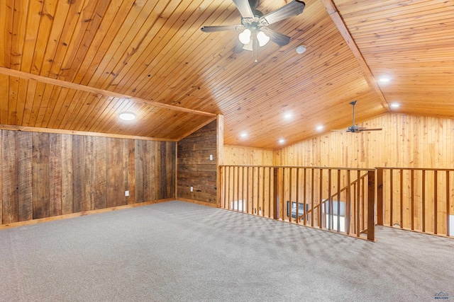 bonus room featuring ceiling fan, wood walls, carpet floors, vaulted ceiling, and wood ceiling