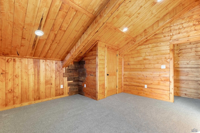 additional living space featuring carpet floors, wooden ceiling, vaulted ceiling, and wooden walls