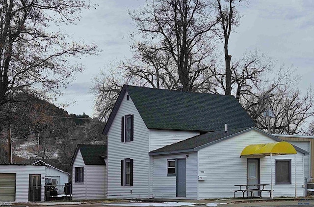 view of front of home with an outdoor structure and a garage