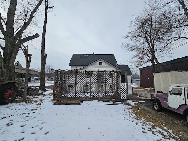 view of snow covered back of property