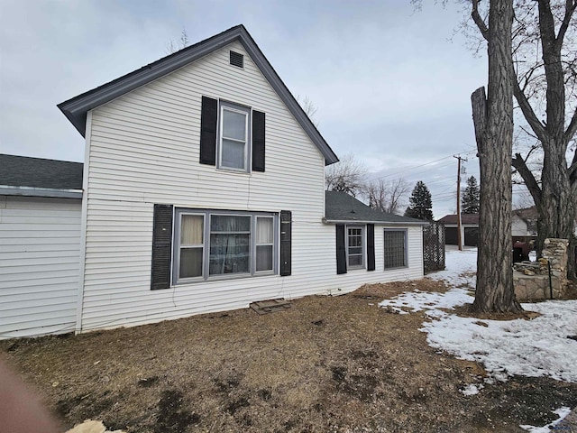 view of snow covered back of property