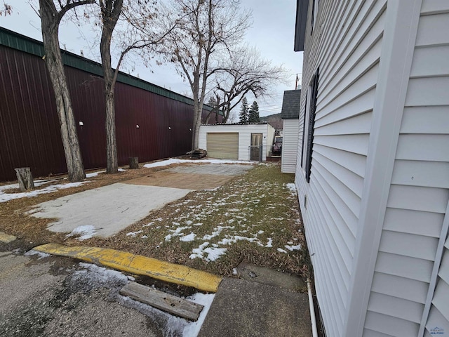 yard covered in snow with an outdoor structure