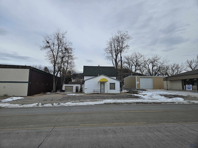 view of front of house with a garage and an outdoor structure