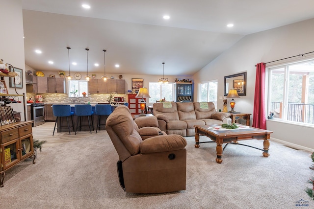 living room featuring light colored carpet and vaulted ceiling