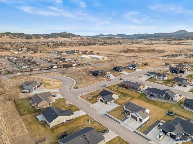 birds eye view of property with a mountain view