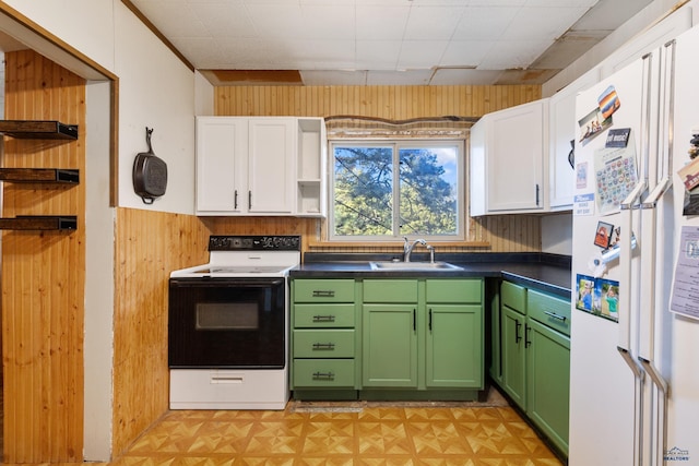 kitchen featuring white appliances, sink, white cabinetry, green cabinets, and wood walls