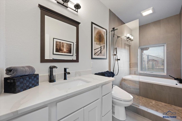 full bathroom with vanity, shower with separate bathtub, and toilet