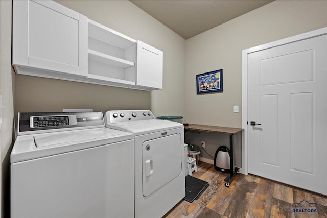 laundry room with cabinets, dark wood-type flooring, and washing machine and clothes dryer