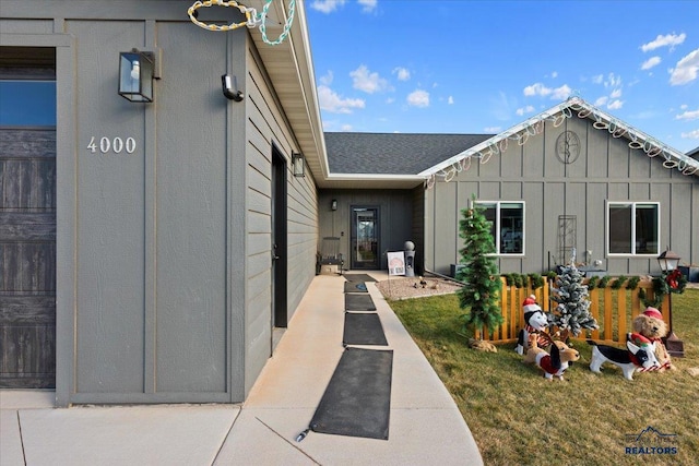 entrance to property featuring a lawn