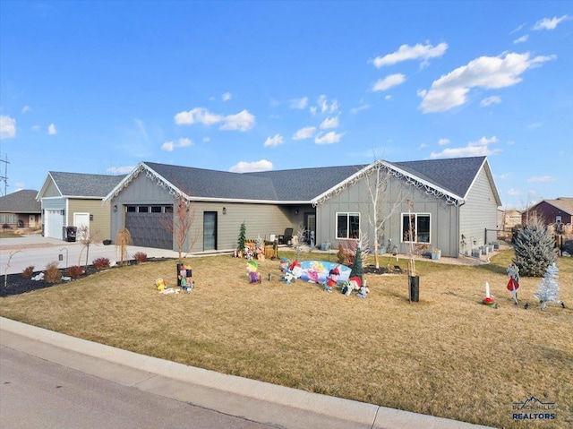 view of front of property with a front yard and a garage